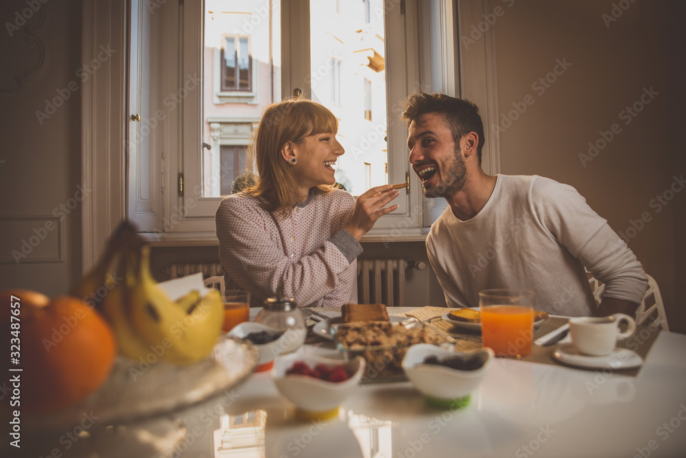 Happy couple making breakfast at home. Concept about lifestyle, healthy food and relationship