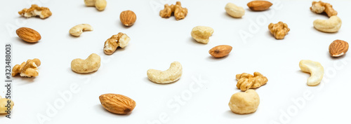 Creative layout made of hazelnut nuts, almonds, walnut, peanut, pecan, sunflower seeds on white background.Flat lay. Food concept.