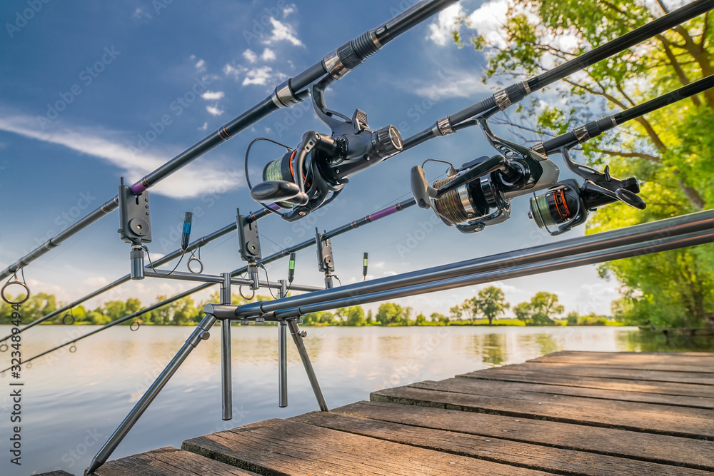 Carp fishing. Rods on rod pod on wood platform at lake Carp fishing. Rods on rod pod on wood platform at lake
