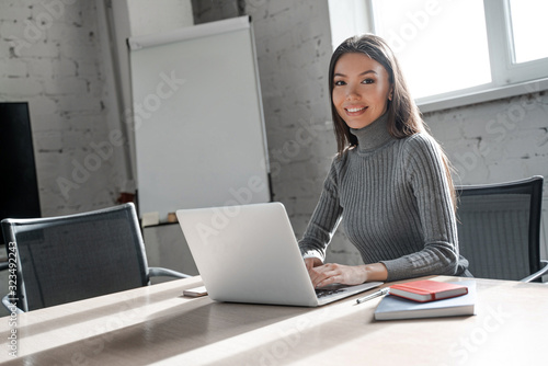 Asian woman work in business finance industry. Business casual style. Successful business strategy plan concept. Confident office worker indoor in coworking space. People lifestyle