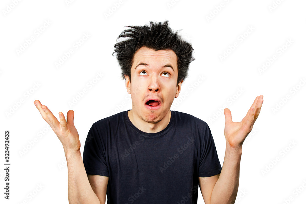 Young white caucasian guy long hair shrug his shoulders and looking up on a white isolated background Young white caucasian guy long hair shrug his shoulders and looking up on a white isolated background