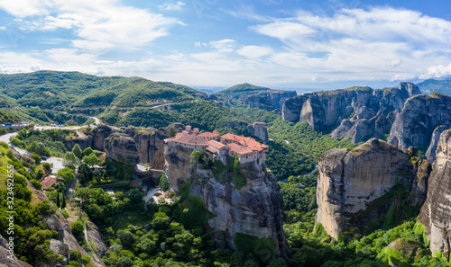 Aerial panorama view of a slide from a drone on a panorama of a mountain range. Kalampaka city, Greece. View of the cliffs of Meteora and the monasteries of Meteora.