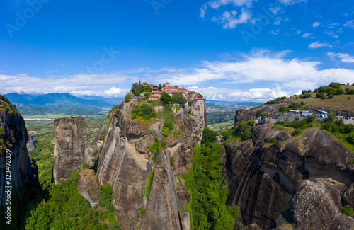 Aerial panorama view of a slide from a drone on a panorama of a mountain range. Kalampaka city  Greece. View of the cliffs of Meteora and the monasteries of Meteora.
