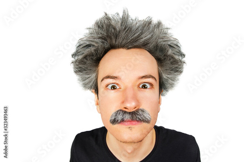 Portrait of jocular aging guy with grey long hair sticking his tongue out in Einstein manner. Isolated on background