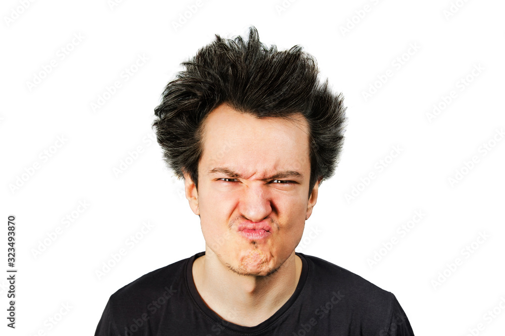 long hair guy wrinkles his nose from sour on his face, on a white isolated background long hair guy wrinkles his nose from sour on his face, on a white isolated background