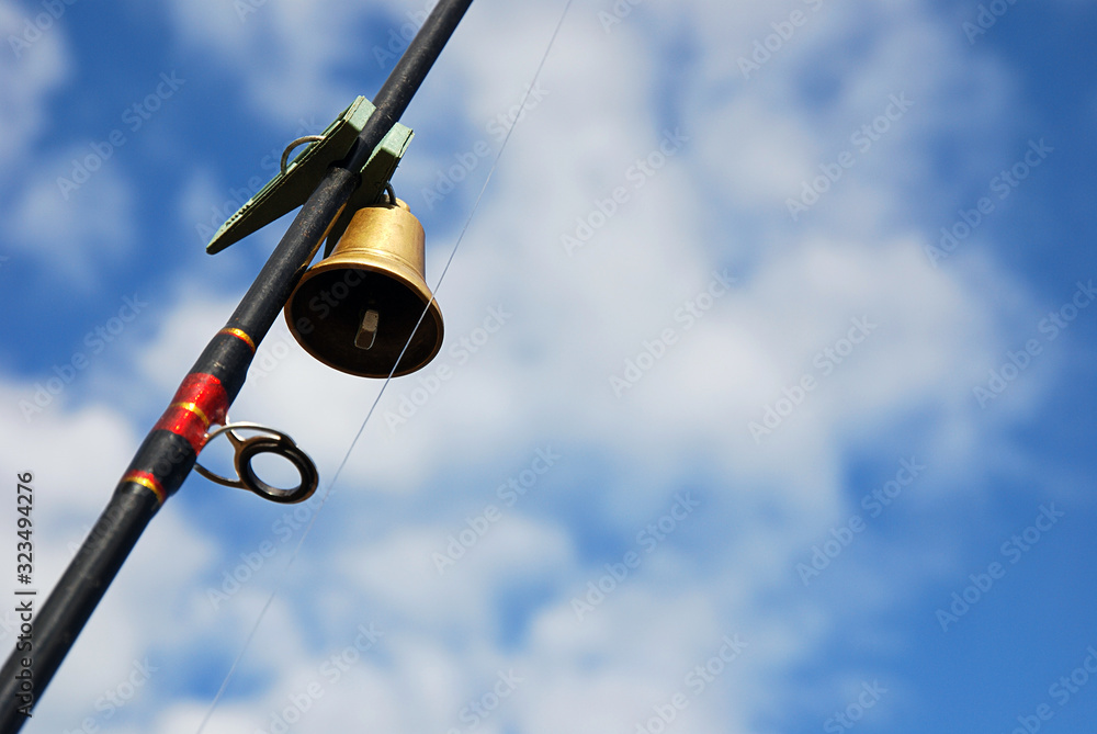 Fototapeta premium Russian Valdai bell fixed with clothespin on leger rig fishing rod. DIY and inventiveness