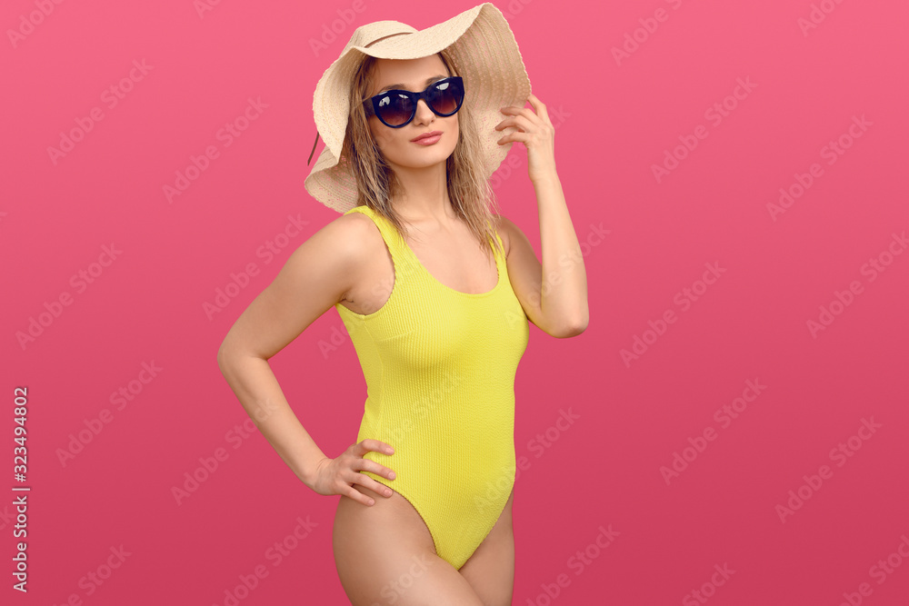 Trendy young woman in a yellow swimsuit