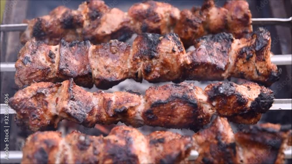 Rotating juicy shashlik over the grill Rotating juicy shashlik over the grill