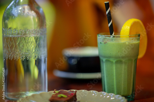 Glass of smoothie at a coffee shop bokeh background