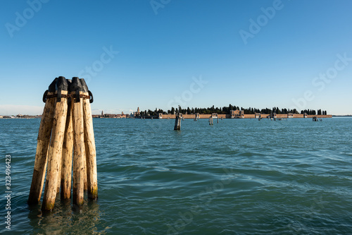 Bollard in front of the cemetery of Venice on a sunny day in winter