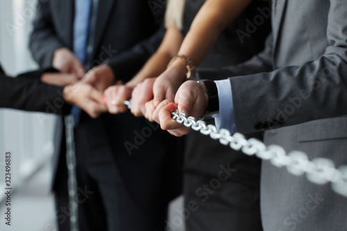 Business team pulling chain