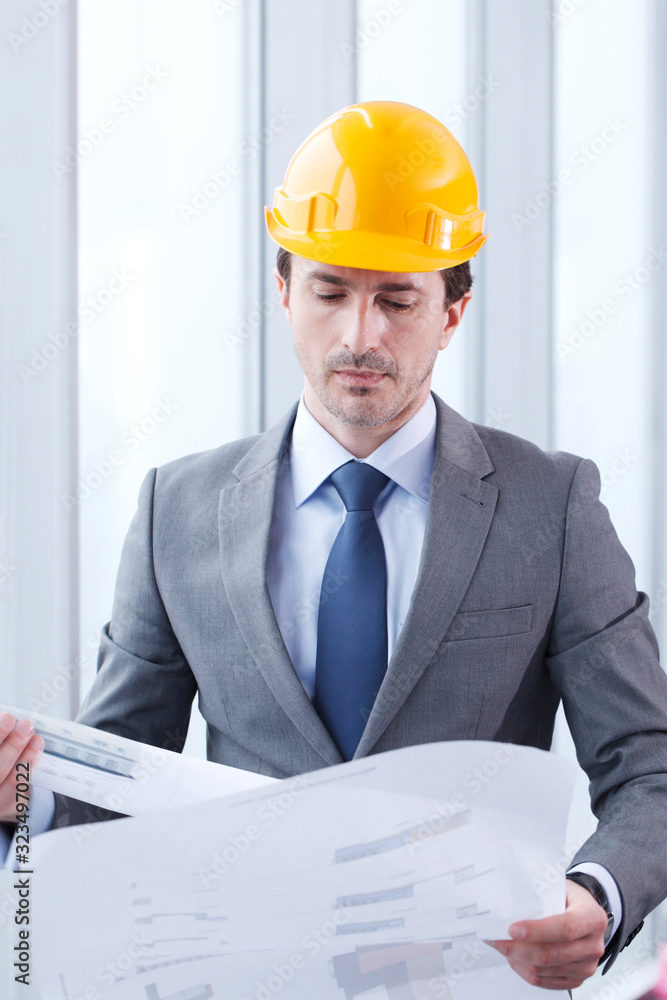 Architect in hardhat with blueprint Architect in hardhat with blueprint