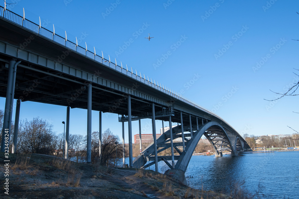 The bridge Västerbron and incoming flight to Bromma airport a sunny winter day in Stockholm