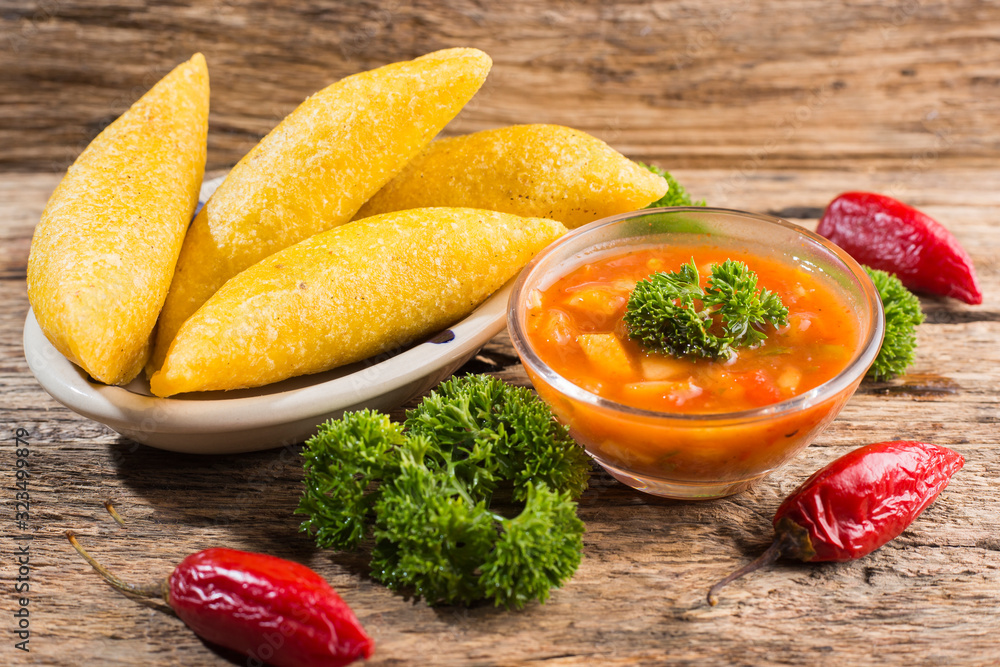 Empanadas with hot sauce, traditional Colombian food Empanadas with hot sauce, traditional Colombian food