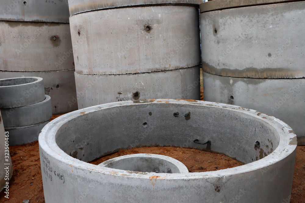Concrete rings in the sand for the installation of water supply networks. Materials for the arbitrariness of construction work. Concrete rings in the sand for the installation of water supply networks. Materials for the arbitrariness of construction work.