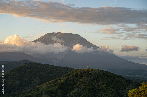 Majestic volcano surrounded by dense white clouds