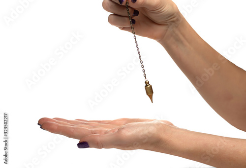 Hand of dowser with hand-held pendulum over the arm. Isolated on white background. photo