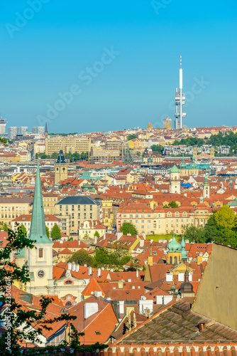 Top view to red roofs and green trees skyline of Prague city Czech republic. © karamysh