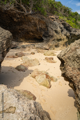 Wild sandy beach with rocks stock photo