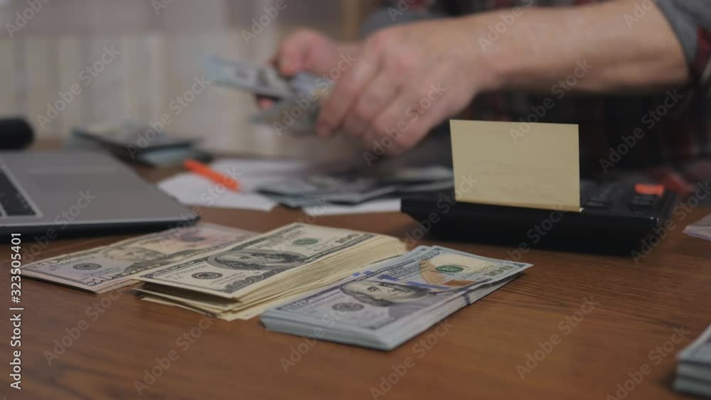 Male retired count cash savings. Close-up hands of an elderly man counting dollar bills. Male retired count cash savings. Close-up hands of an elderly man counting dollar bills.