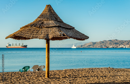 Relaxing facilities on sandy beach in Eilat - famous tourist resort and recre...