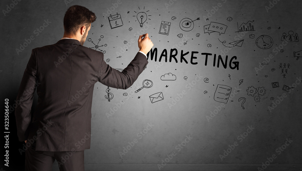 businessman drawing a creative idea sketch with MARKETING inscription, business strategy concept