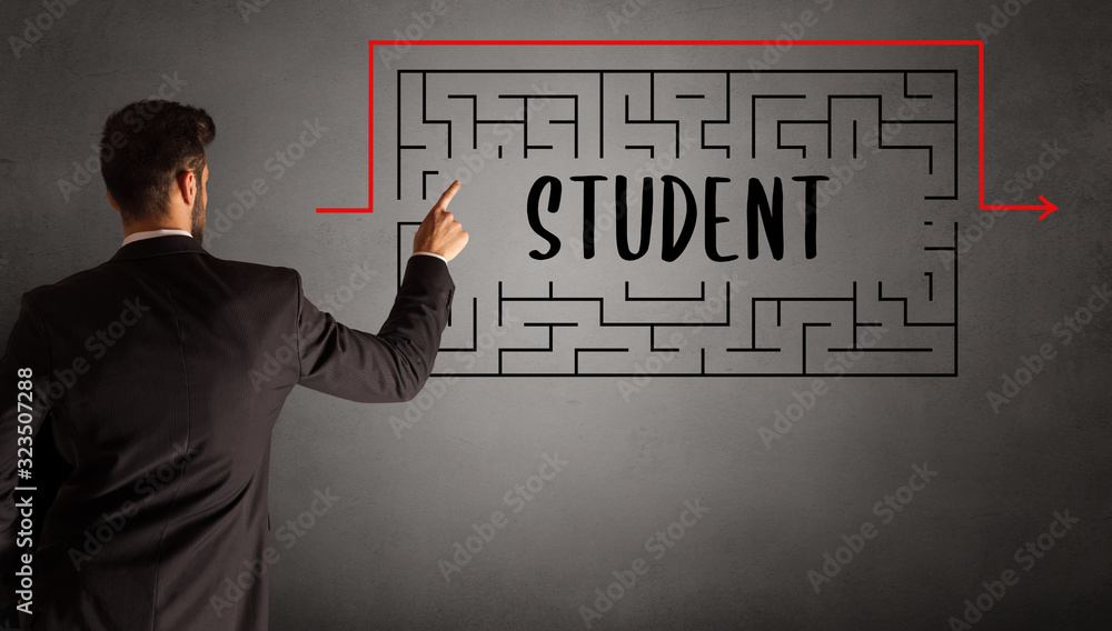 businessman drawing maze with STUDENT inscription, business education concept businessman drawing maze with STUDENT inscription, business education concept