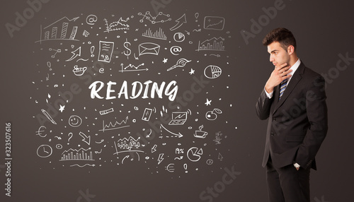 Businessman thinking with READING inscription, business education concept