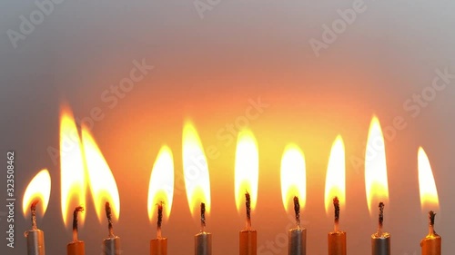 Ten candles in a row , burning