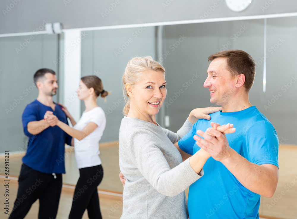 Fototapeta premium Middle aged woman learning to dance waltz