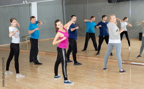 Fototapeta Naklejka Na Ścianę i Meble -  Females and males stretching at dance class