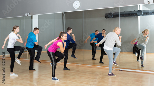 Adult people training in dance studio