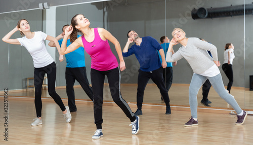 Fototapeta Naklejka Na Ścianę i Meble -  Adult people training in dance studio