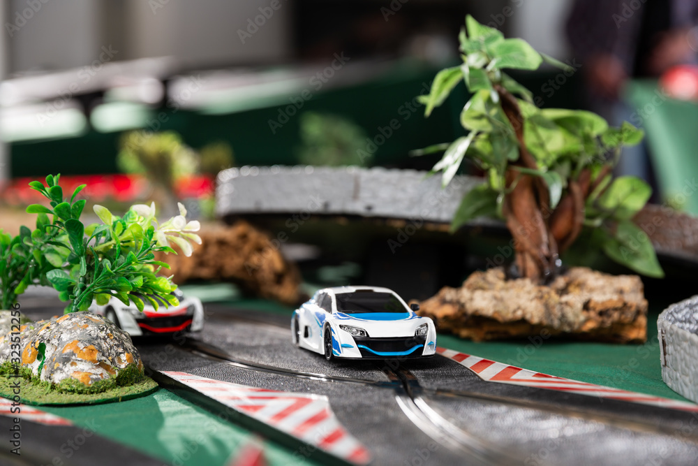 Electric slot cars on toy race track
