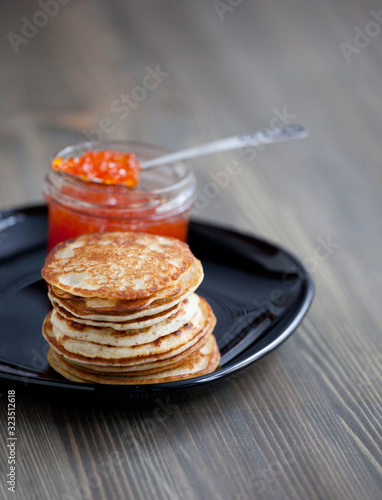 Stack of thin Russian pancakes with caviar for Shrovetide Butter week festival meal, pancakes day meal, Shrove Tuesday ( Mardi gras and Fat Tuesday) photo