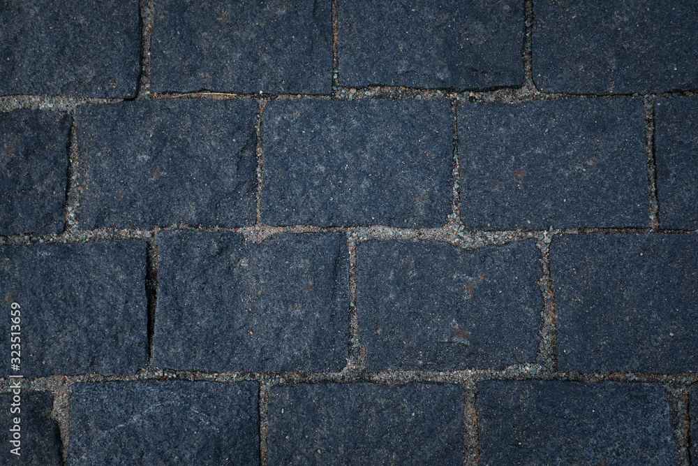 Dark grey stone road texture.
