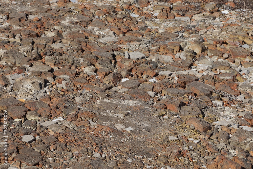 Fototapeta premium brown stone texture of dirty cobblestones and old bricks in the sidewalk on the street