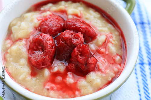 Tasty oatmeal porridge with raspberries photo