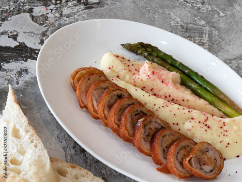 Cordon bleu chicken fillet with asparagus and grany sauce photo