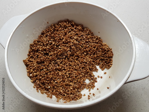 Wet buckwheat porridge in a white pan