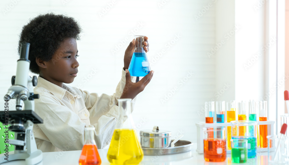 African black boy study chemical , science seriously with experimenting at laboratory. African black boy study chemical , science seriously with experimenting at laboratory.