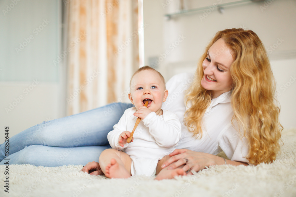 mom blonde and baby with bamboo toothbrush mom blonde and baby with bamboo toothbrush
