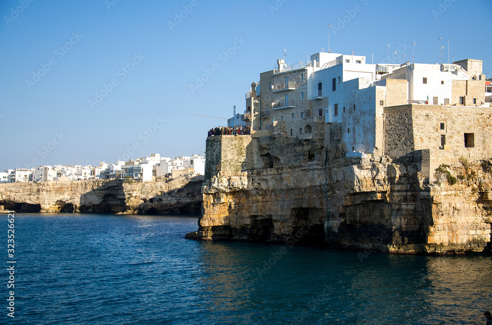 White buildings on grottos and cliffs in the town of Polignano a mare in Puglia Apulia region, Southern Italy