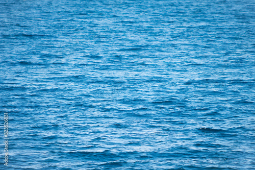Close up of water ripples, pacific ocean. Foreground in focus, background blurred