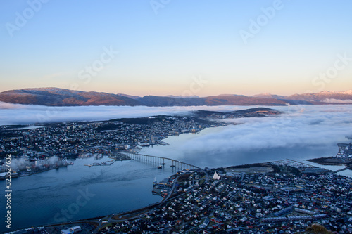 Obraz na płótnie A beautiful cityscape of Tromso (including the Artic Cathedral) with low altitude cloud taken from Fløya during sunset w salonie