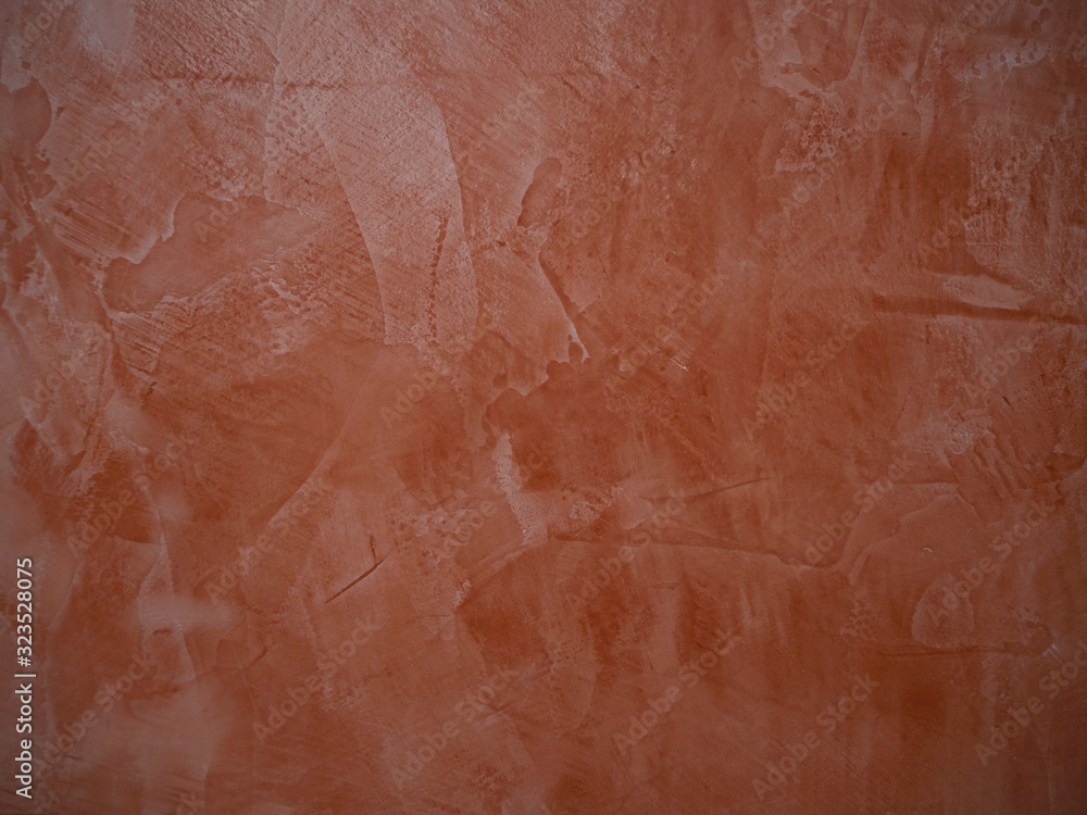 Coral painted grunge wall with bumps and scratches, modern interior decoration abstract background.