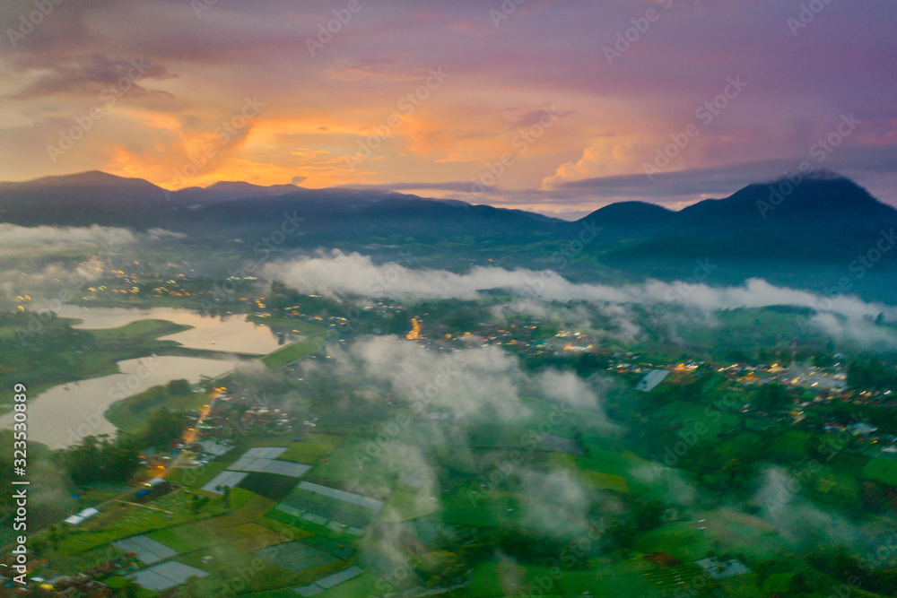 Aerial scenery of fog above village on morning