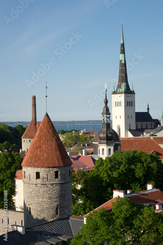 Tallinn, Estonia, street of the old city with bright houses and spike of St Olaf (Oleviste) Church