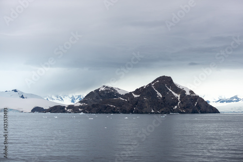 Antarctic beach with glacier and mountains, view from expedition ship © Alexey Seafarer
