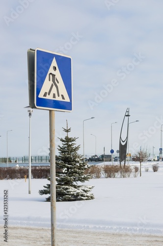 Road sign "Pedestrian crossing" against blue sky